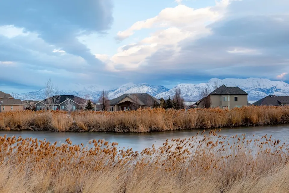 Homes in Saratoga Springs, Utah with pond in foreground.